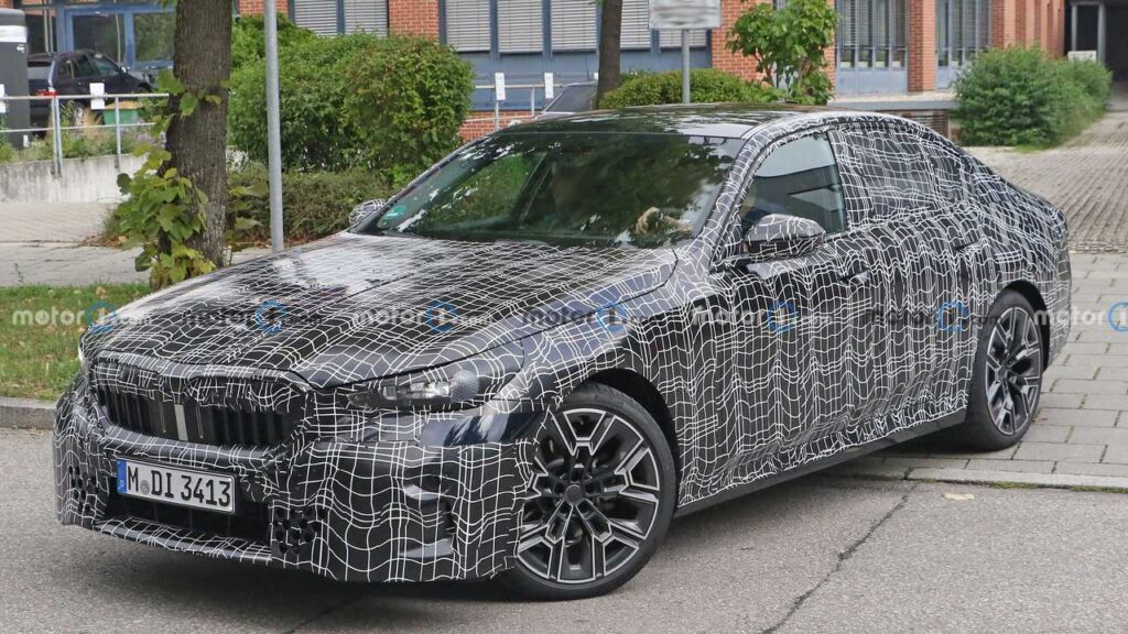 BMW M5 spotted with production headlights & thinner camouflage