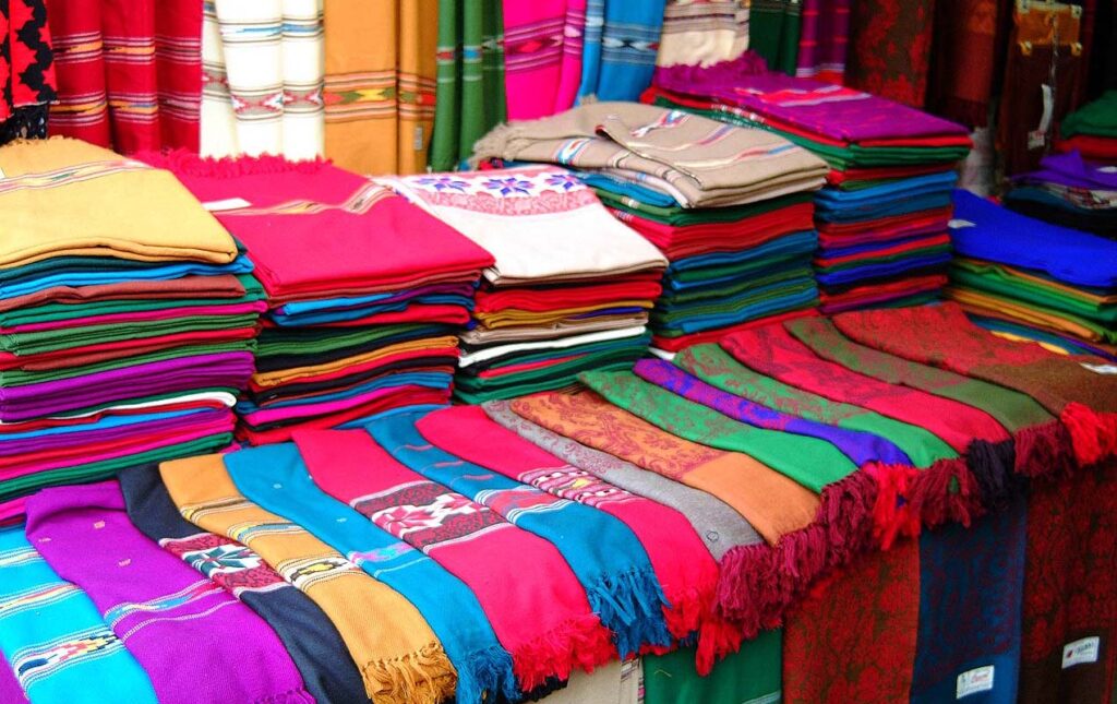 A vibrant assortment of fabric showcased at a bustling pakistan's textile market