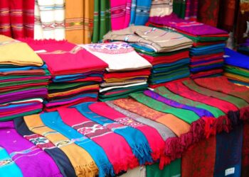 A vibrant assortment of fabric showcased at a bustling pakistan's textile market